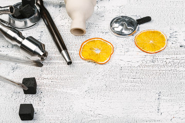 Parts of hookah and fruits on wooden background