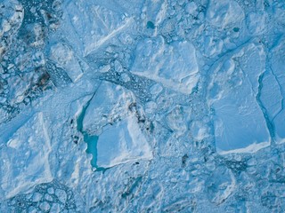 Icebergs drone aerial image top view - Climate Change and Global Warming. Icebergs from melting glacier in icefjord in Ilulissat, Greenland. Arctic nature ice landscape in Unesco World Heritage Site.