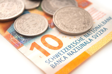 Coins and bank note of Switzerland on white background