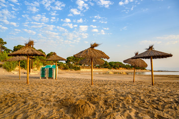 Natural Beach Umbrellas and sun loungers on a beach
