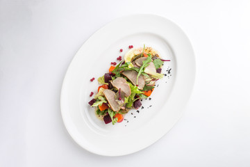 Salad with duck, spicy pumpkin and beetroot isolated on white background