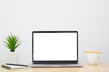 Laptop computer blank screen on wood desk. Minimal style desk.