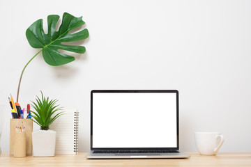 Laptop computer blank screen on wood desk. Minimal style desk.