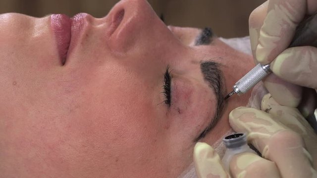 Young girl doing microblading procedure