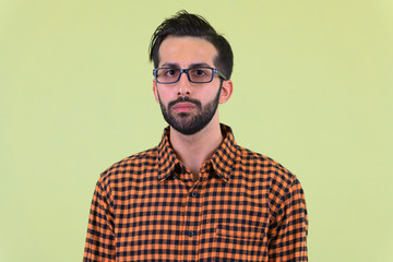 Face of young bearded Persian hipster man