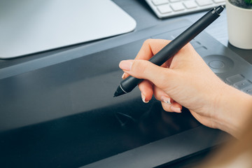 Woman hands graphic designer working on digital tablet