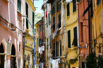 Fototapeta na wymiar Porto Venere in Italy, typical narrow old town street with colourful houses and clotheslines