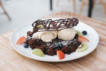 Chocolate crumble, Vanilla ice creams on chocolate cookies  crumbles with blueberries,  strawberries and kiwis