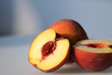 fresh peaches on white surface