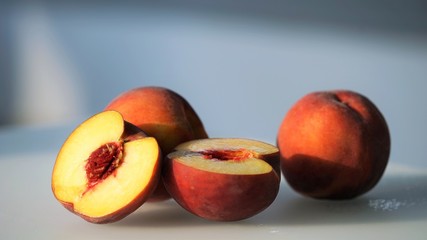 Fototapeta na wymiar fresh peaches on white surface