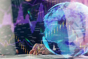 Forex graph with businessman typing on computer in office on background. Concept of analysis. Double exposure.