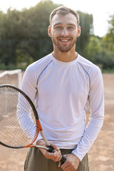 Front view smiling man on tennis court