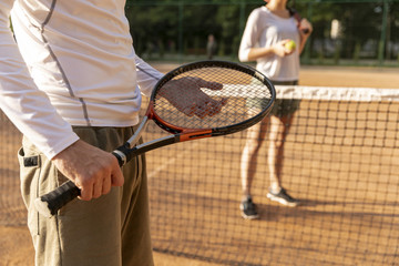 Close-up man holding tennis racket