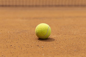 Close-up tennis ball on court ground