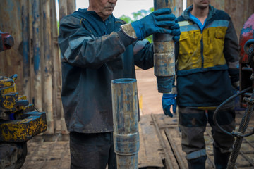 Offshore oil rig worker prepare tool and equipment for perforation oil and gas well at wellhead...