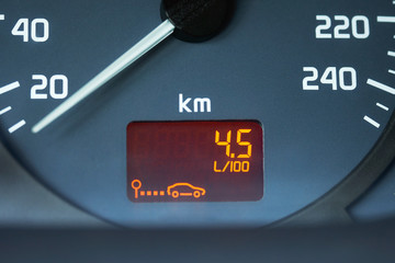 On-board computer of a car shows a low petroleum consumption. The figures on the dashboard show the...