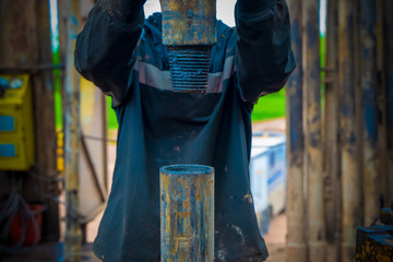 Offshore oil rig worker prepare tool and equipment for perforation oil and gas well at wellhead...