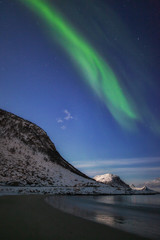 Fototapeta na wymiar Northen light under mountains. Beautiful natural landscape in the Norway