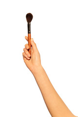 Female hand holding professional makeup brush on white