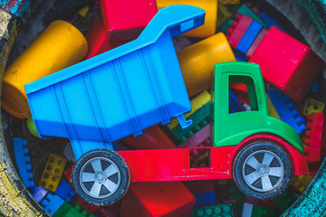 Sand box with color toy car and constructor bricks