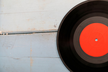 Vintage record LP, smartphone and headphones on the wooden background