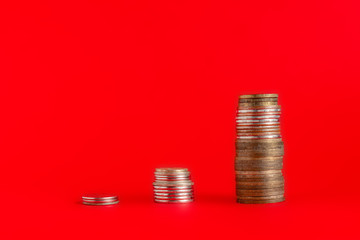 stack of cash coins showing increase graph on color surface