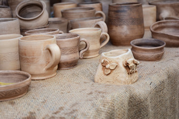 Traditional Ceramic Jugs of Handmade Ceramic Pottery in a Roadside Market with Ceramic Clay Caps  Outdoors.