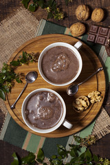 Hot chocolate and spoons on wooden board