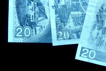 Fototapeta premium Different bills in twenty Hong Kong dollars close up. Money background blue color toned