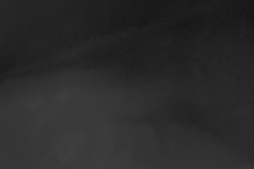 Hand painted black alcohol ink background. Abstract delicate gray texture. Contemporary wallpaper. Fog effect.