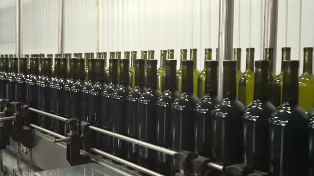 Bottling and sealing conveyor line at winery factory