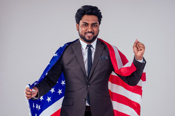 business male wrapped up american flag in studio white background