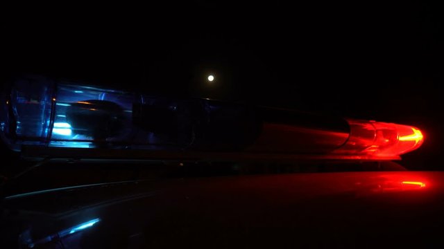 Police blue and red lamp flashing spinning in the dark