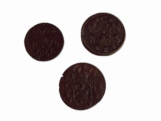 Photo of three 17th century Swedish copper coins isolated on a white background.