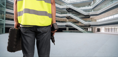 Fototapeta premium Construction Worker in front of construction site