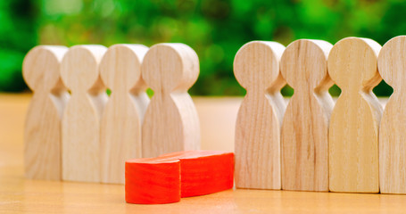 The red figure of a man falls out of the line of people. Concept of employee dismissal and...