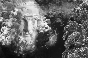 Face of ancient statue on a underwater background with corals and fish. Art, adventure, underwater...
