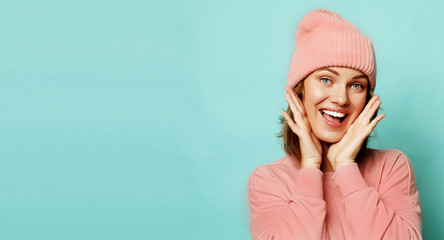 Image of happy young lady wearing pink hat and sweater 
