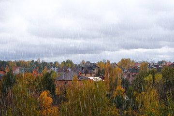 Autumn on outskirts of city. Bright blue sky with thick clouds. September, October, November. Rainy day.
