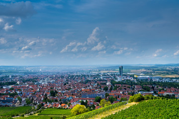 Fototapeta na wymiar Germany, Fellbach city houses and roofs from above kappelberg vineyards in summer while rain going down over the city centre