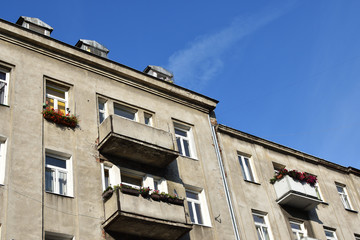Grey facade of an old damaged slum house with decorated balconies in a poor and criminal district. Location: Brzeska street, Praga district of Warsaw city, Poland - 282630808
