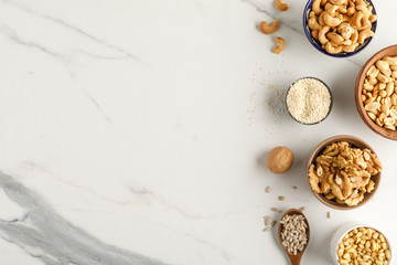 Frame made of different types of nuts in bowls