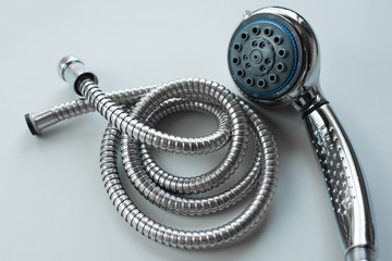 New set steel shower head sprayer with metal shower hose for the bathroom with power regulator on a...