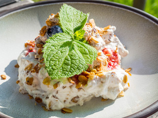 Cranachan, traditional Scottish dessert with whipped cream, whisky, honey, strawberries, blueberry and oatmeal