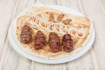 juicy, fried, tender steak with vegetables and sauces on a special stand