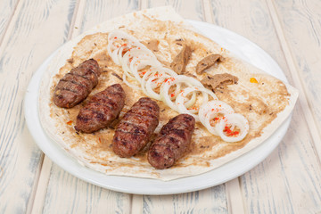 juicy, fried, tender steak with vegetables and sauces on a special stand