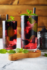 Refreshing summer cocktail with blackberry