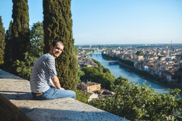 Fototapeta na wymiar man enjoying view on city and river