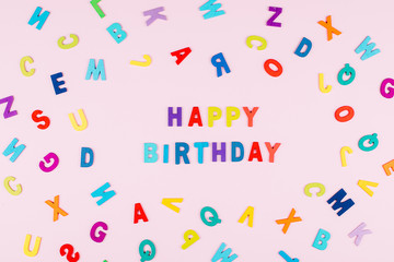 Happy Birhday Card. Bright multicolored alphabet background with word "Happy Birthday". Flat lay, top view