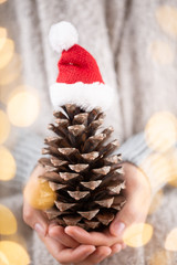 Christmas decor in women hand. Christmas greeting card. Woman's hands hold christmas or new year decorated gift.